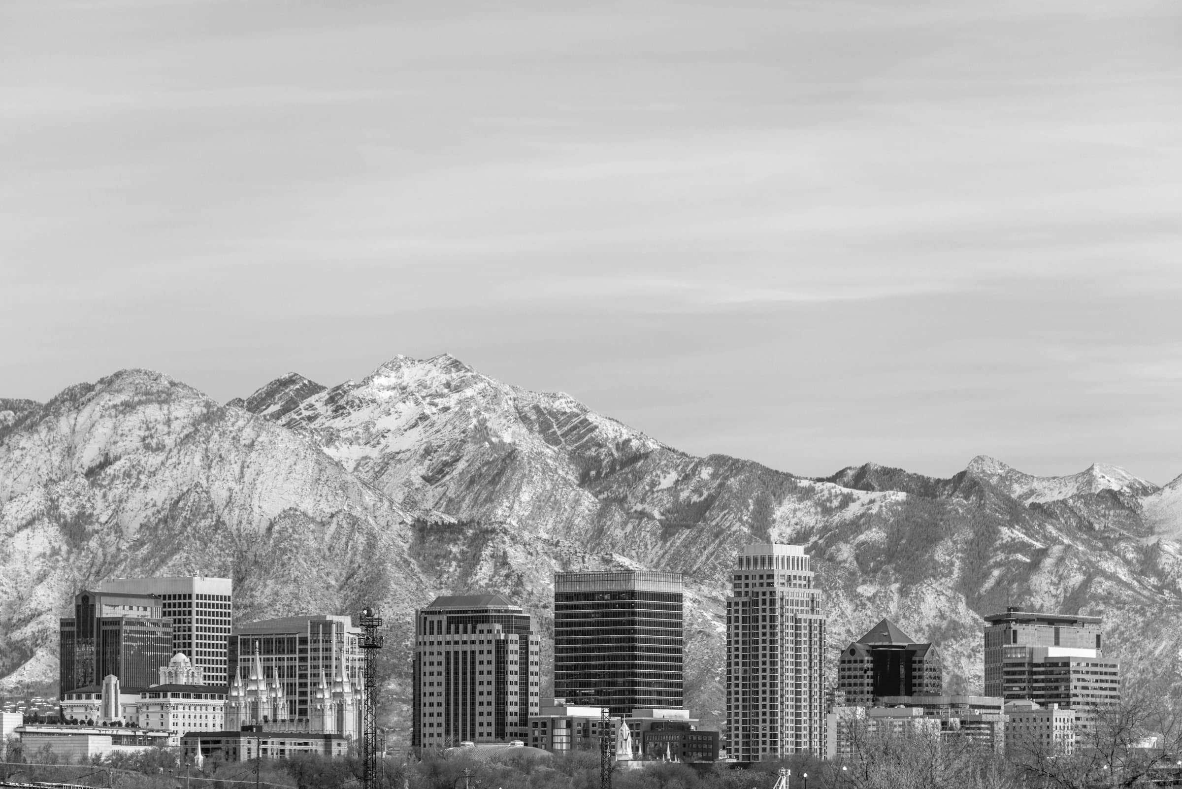 Downtown Salt Lake City skyline in winter, with snow-capped mountains behind it